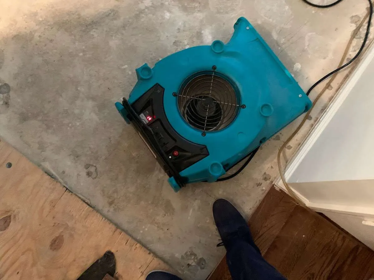 Air mover drying subfloor during Commercial Water Damage Restoration in Terrell Hills